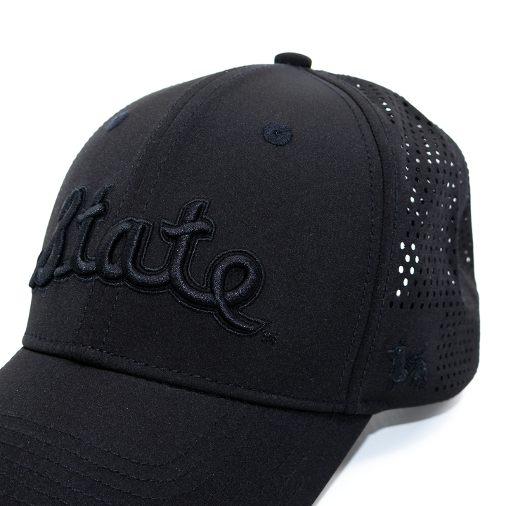 Close up of the Michigan State all black cursive State Script hat from Nudge Printing.