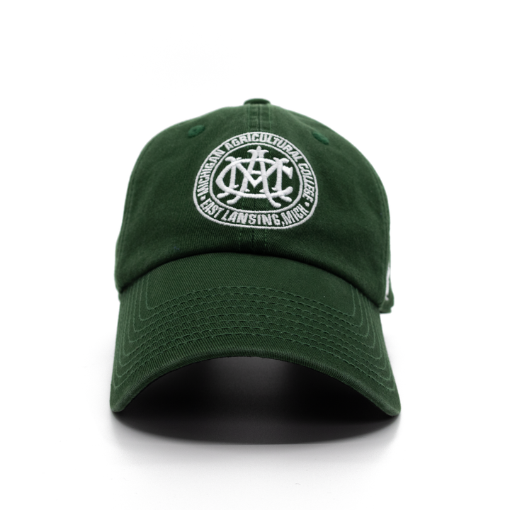 Front profile of the Michigan State MAC (Michigan Agricultural College) forest green dad hat from Nudge Printing