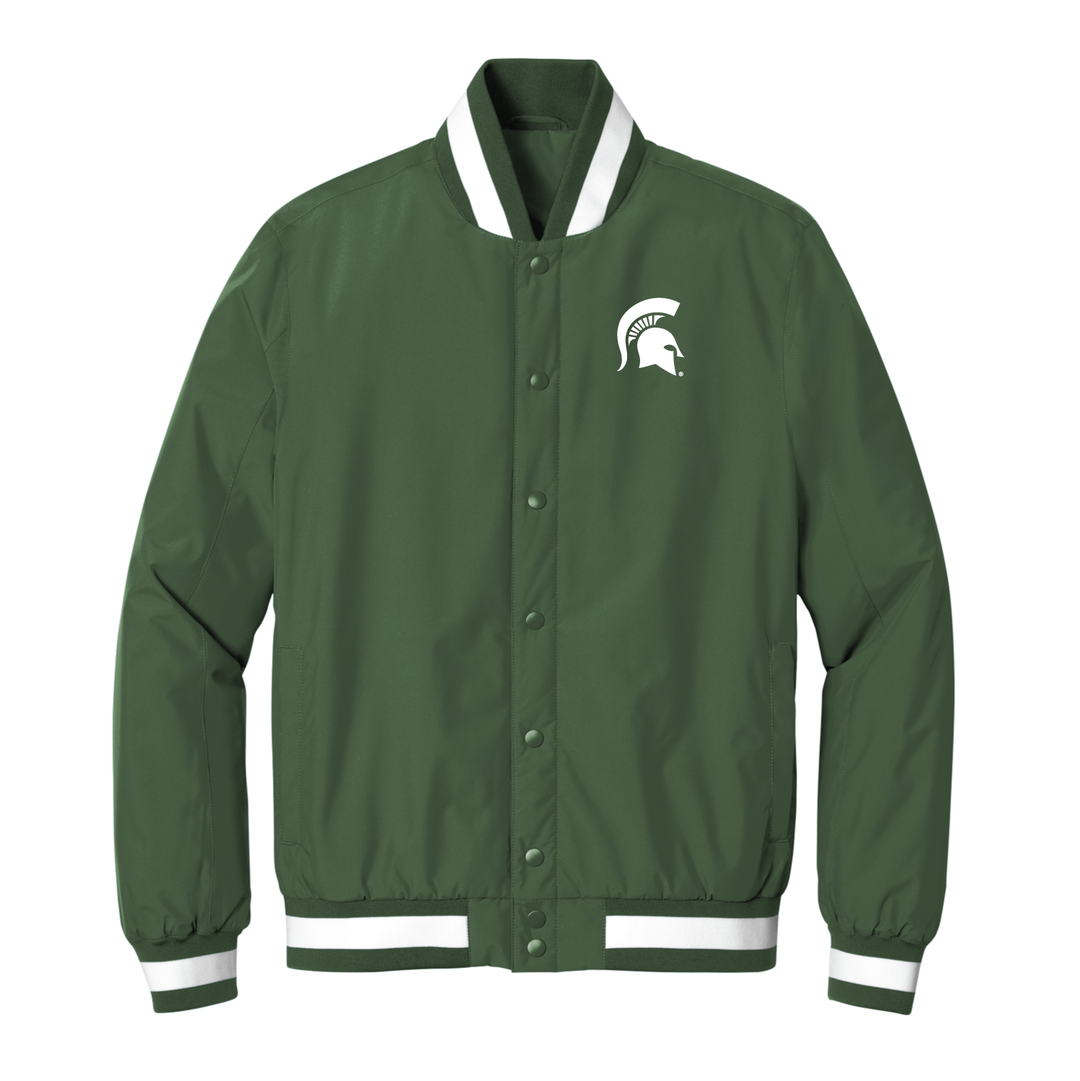 Front view of a Michigan State Varsity jacket with a white Spartan Helmet logo embroidered on the left chest . 